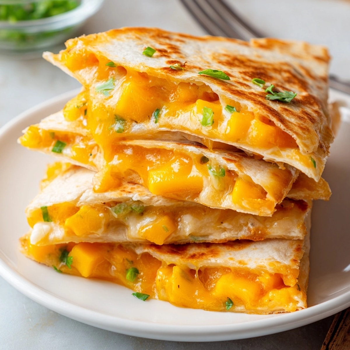 Warm, crispy Cheesy Mango Quesadilla Triangles, a delightful savory-sweet snack ready to share.