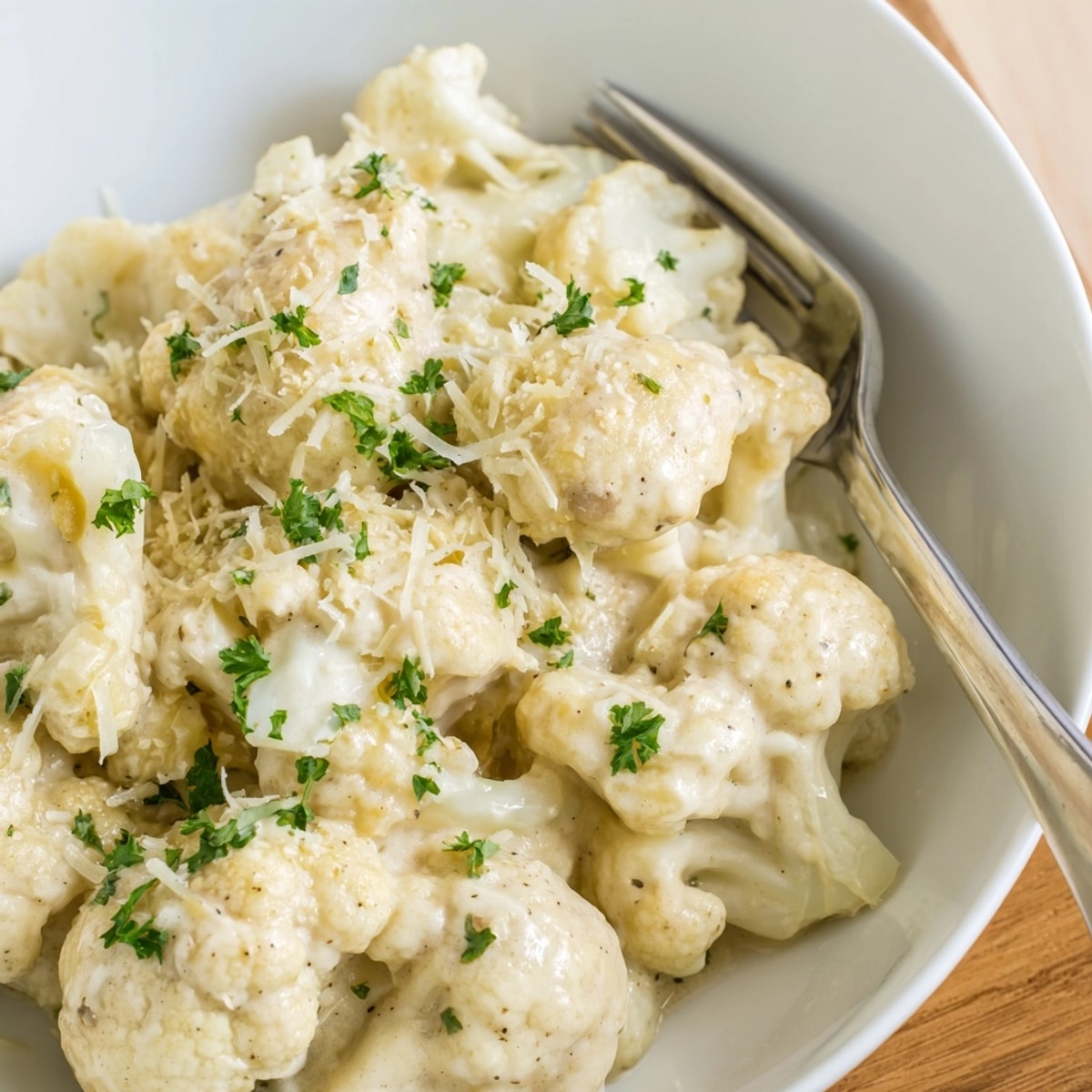 Golden-brown cauliflower florets coated in rich, homemade Alfredo sauce—Alfredo Cauliflower Garlic Skillet.