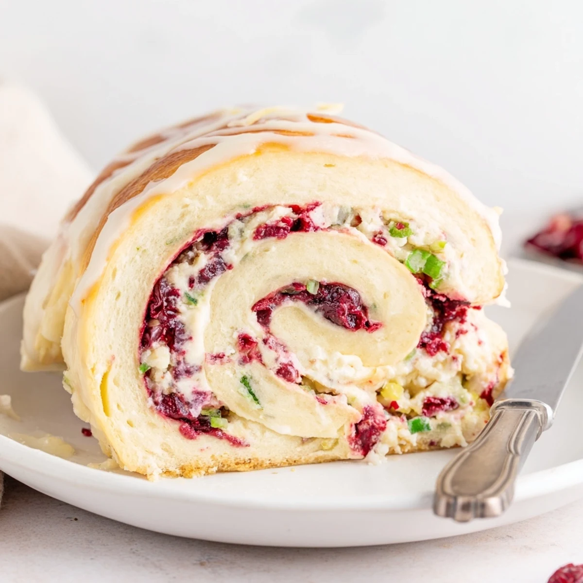Creamy cranberry jalapeño dip nestled in soft Philly rolls, perfect for party appetizers.  
