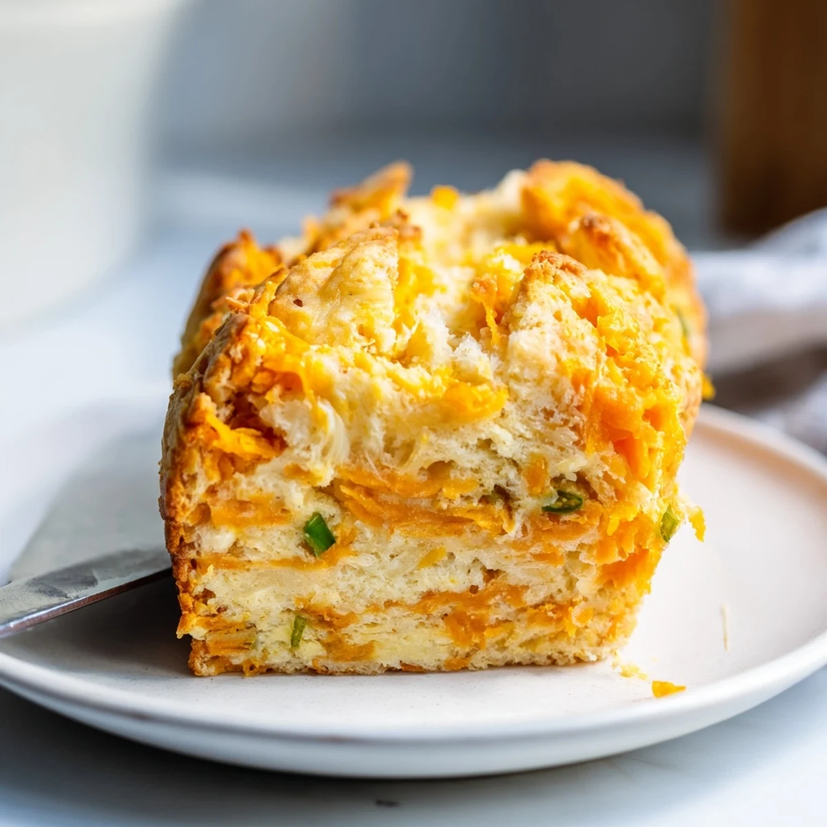 Moist Sweet Potato Cheesy Jalapeño Biscuit Muffin Loaf cut into thick slices, perfect for brunch.