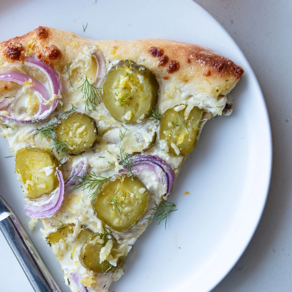 Unique Pickle Pizza showcasing golden crust, melted cheese, and tangy dill accents.