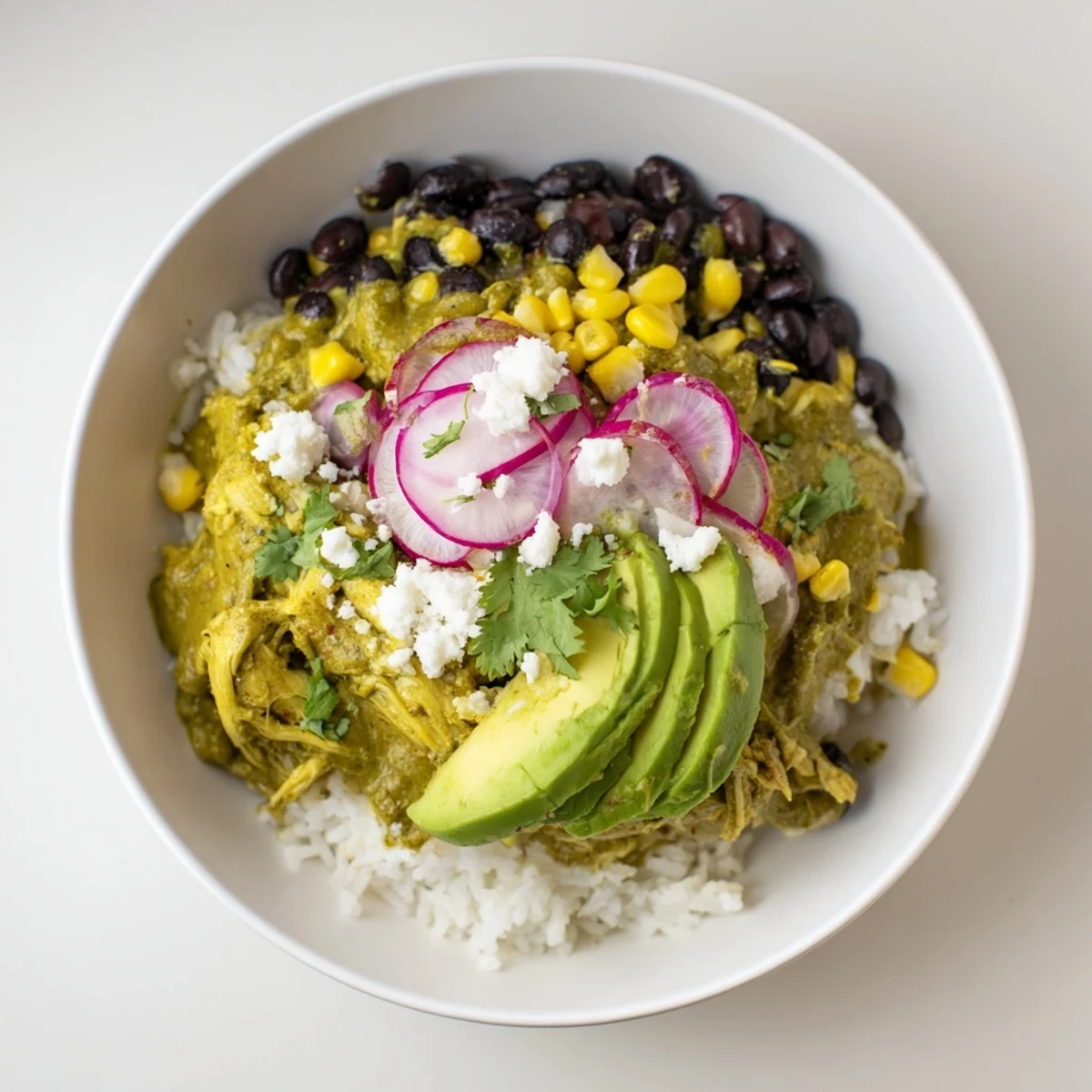 Enjoy a view of a loaded Green Enchilada Rice Bowl, perfect for a gluten-free and flavorful dinner.