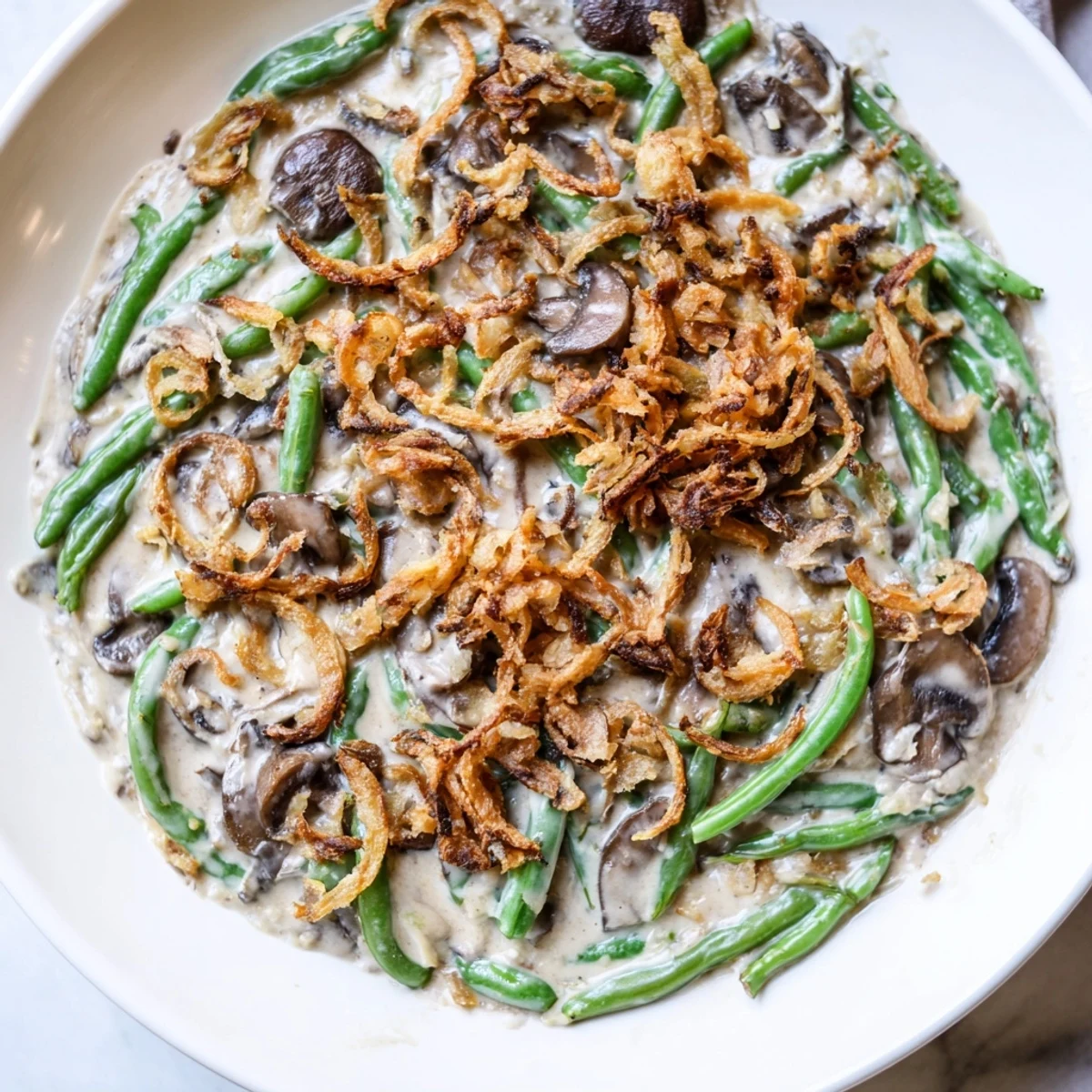 Golden-brown Old-School Green Bean Casserole topped with crispy fried onions, ready to be served.