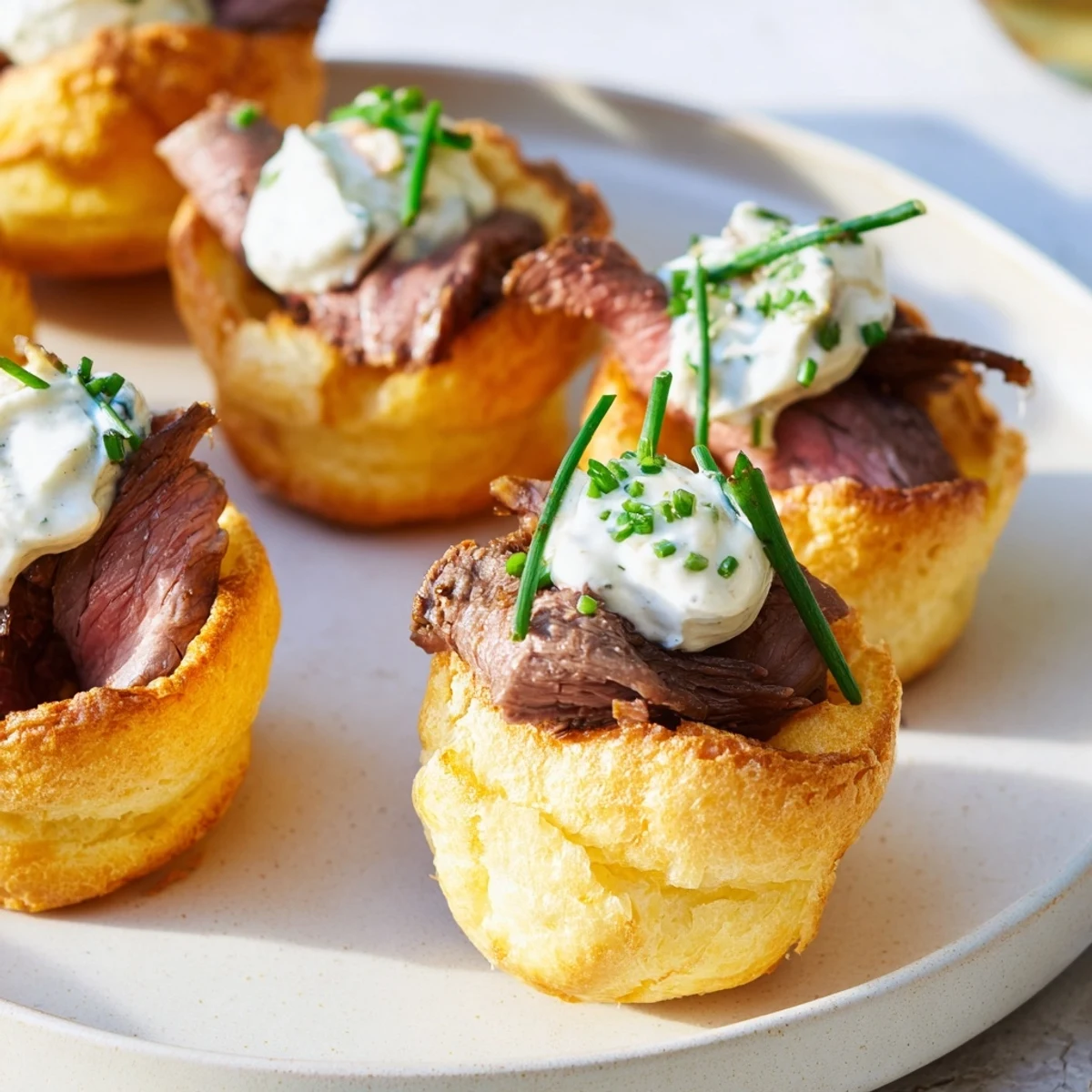 Crispy bite-sized Express Holiday Yorkshire Pudding Bites, showcasing savory roast beef and chive-topped filling.