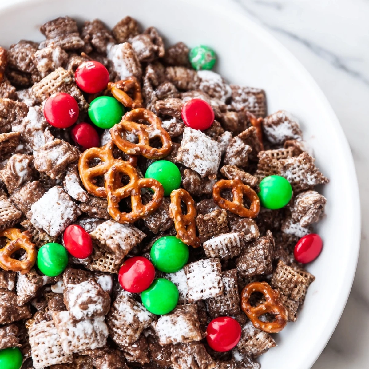 Sweet, chocolatey Simplified Reindeer Chow poured onto a baking sheet, ready for cooling and enjoyment.