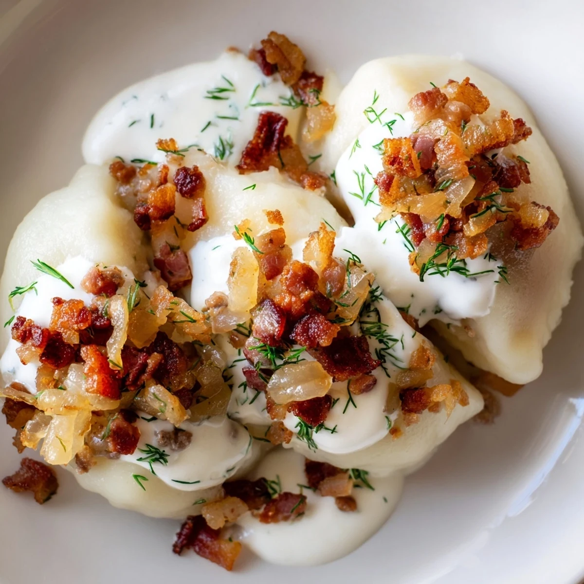 Steaming Lithuanian Cepelinai dumplings, beautifully oval-shaped, served with creamy bacon sauce.