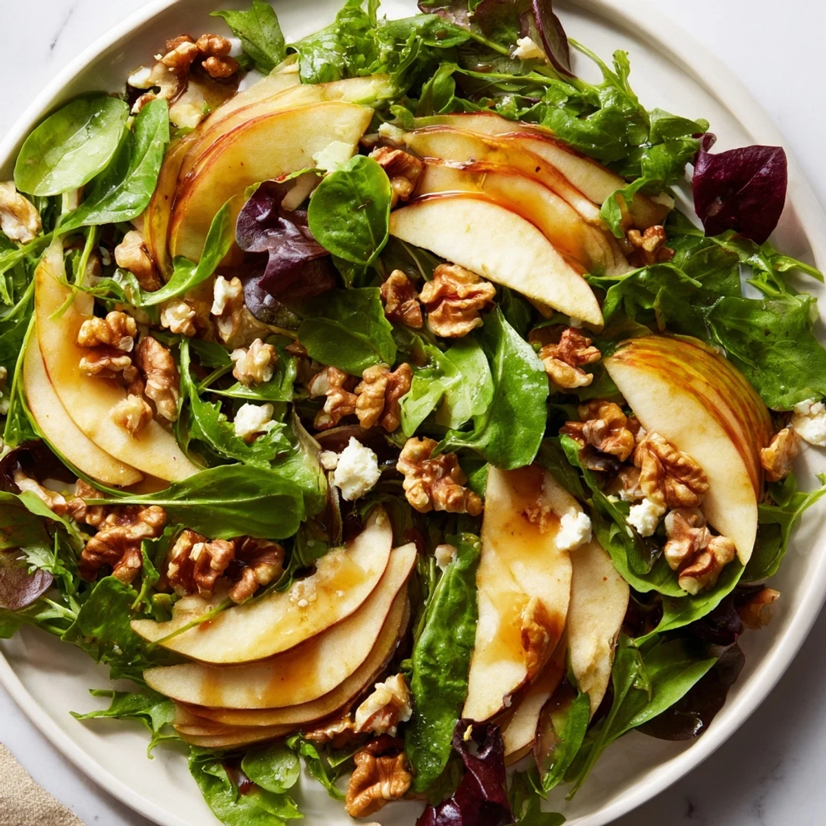 Healthy Apple and Walnut Salad on a white plate, ready to serve as a refreshing vegetarian side dish.