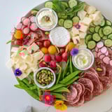 A close-up of a Dragonfly Dance appetizer tray, overflowing with fresh, delicious ingredients.
