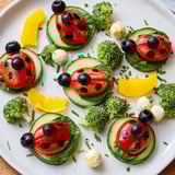 This colorful Ladybug Garden Platter appetizer includes playful ladybug veggie arrangements on a platter.