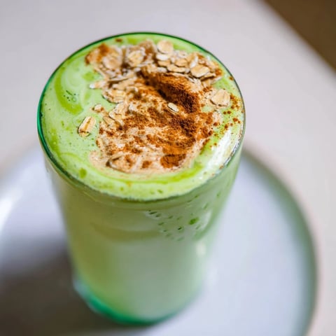 Creamy Matcha Snickerdoodle Protein Shake, a vibrant green, with a swirl of cinnamon and almond butter.