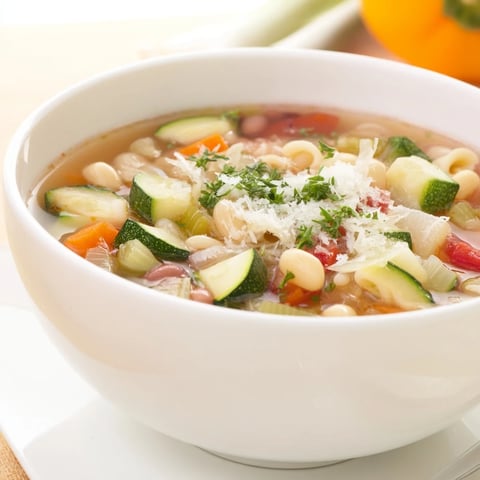 Steaming bowl of Veggie-Packed Minestrone Christmas Pasta Pot, ready to warm you and your family.