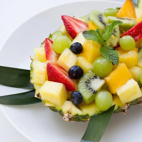 Vibrant Tropical Pineapple Fruit Boat brimming with fresh, colorful tropical fruits, perfect for summer.