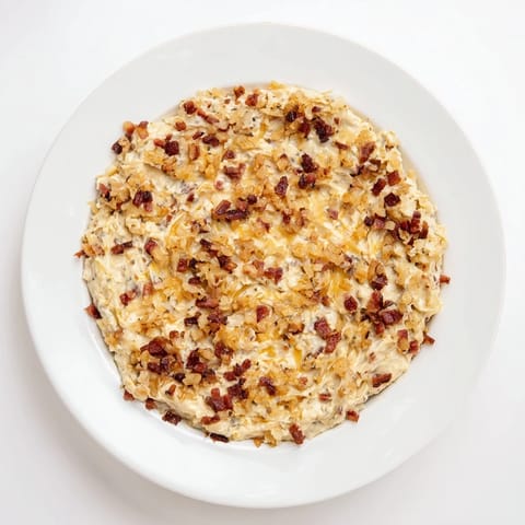 Close-up of creamy Caramelized Onion and Bacon Dip, a savory party food everyone loves.