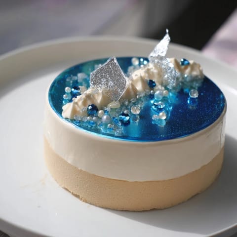 This beautiful Diamond Ring Engagement Cake offers elegant flavors with layers and a mirror glaze.