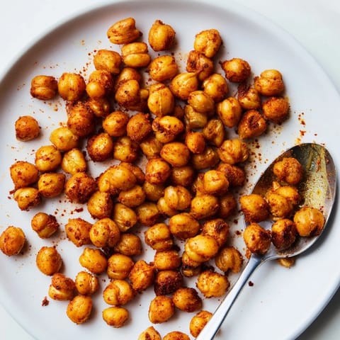 Crispy chickpea snack, freshly baked with smoky seasoning, ready to enjoy as a healthy protein-rich crunch.  
