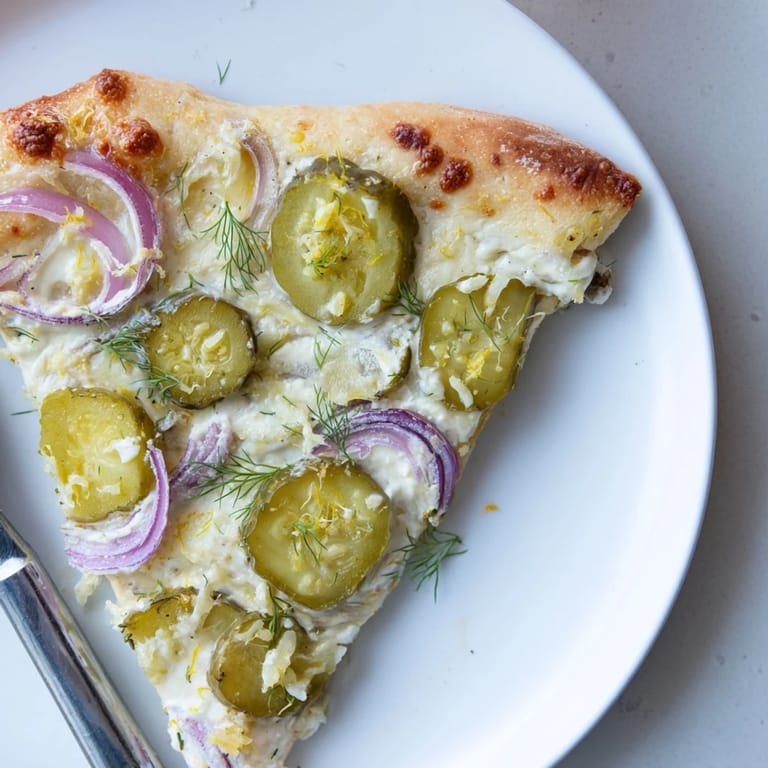 Unique Pickle Pizza showcasing golden crust, melted cheese, and tangy dill accents.