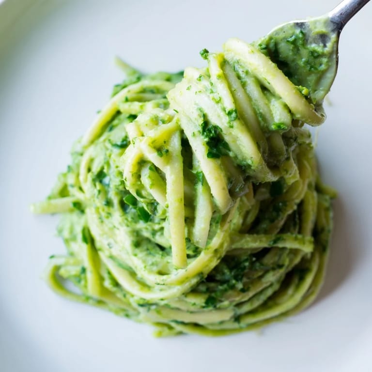 Linguine coated in bright green goddess sauce, a flavorful and easy pasta creation.