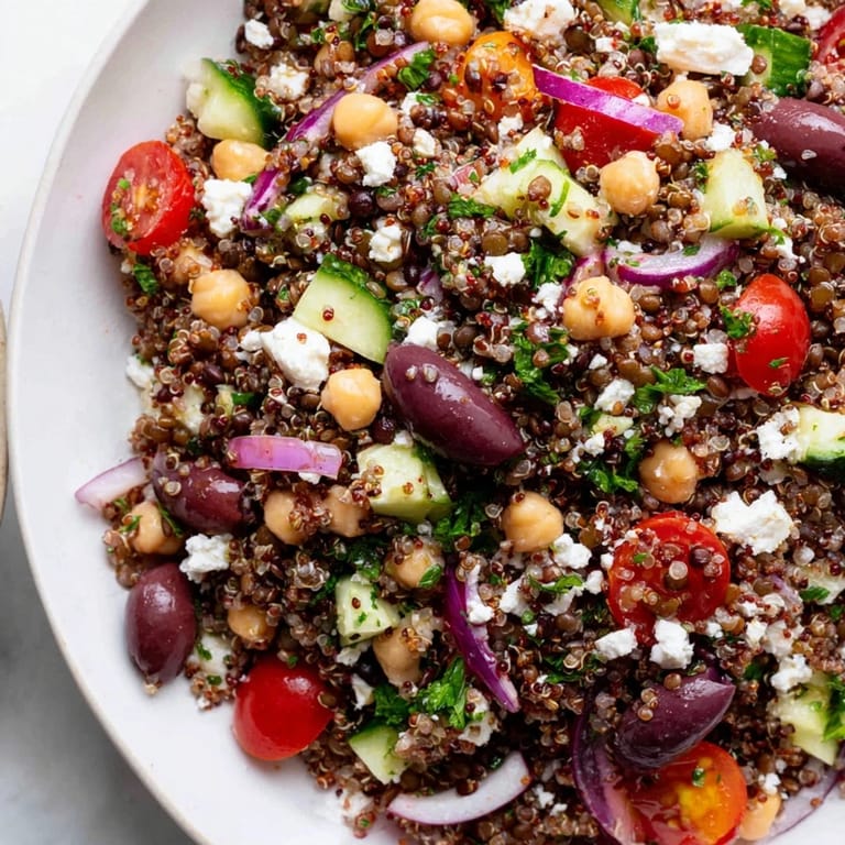 A hearty serving of Greek Power Salad in a shallow dish, highlighting the colorful mix of vegetables and legumes perfect for a nutritious lunch.