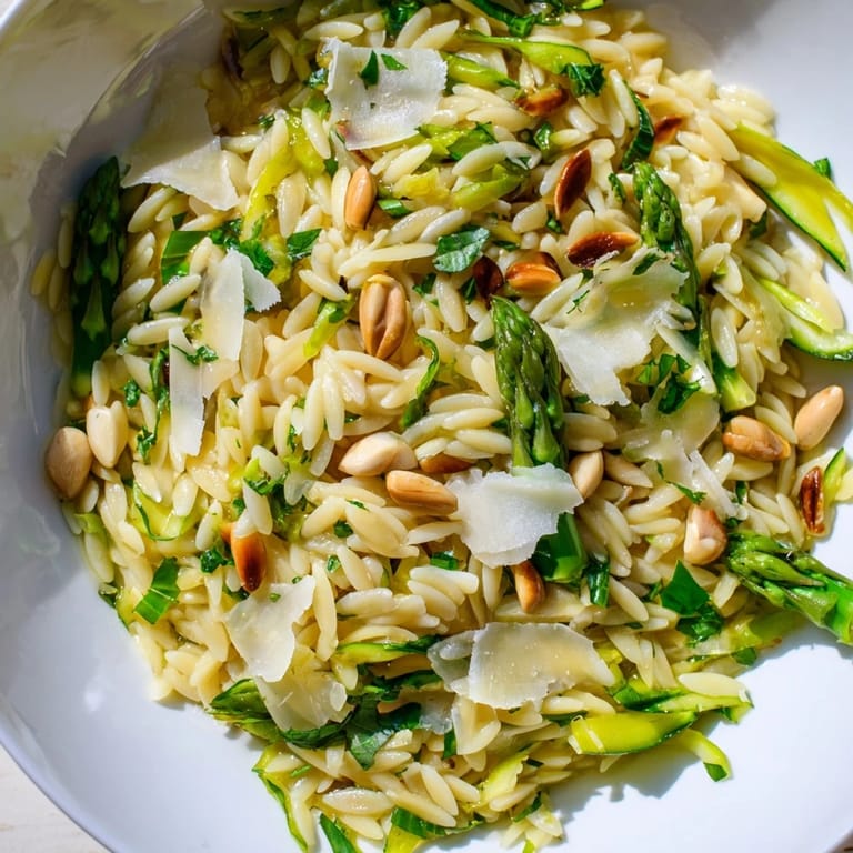 Cold orzo and crisp shaved asparagus combine with lemony dressing and Parmesan for a refreshing Mediterranean-style side salad.